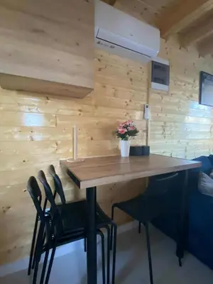 a wooden table and chairs in a room with wooden walls at Sister's House Zator in Palczowice
