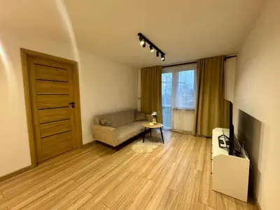 a living room with a couch and a television at Apartament Bałandy 18 in Oświęcim