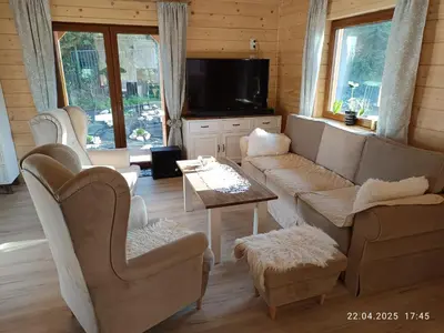 a living room with a couch and chairs and a table at Jura - Chata pod Grodziskiem Pańskim in Domaniewice