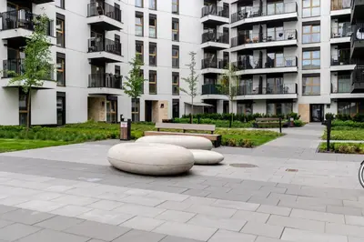 a park in front of a large apartment building at Imperial Capital Apartments by BookingHost in Kraków