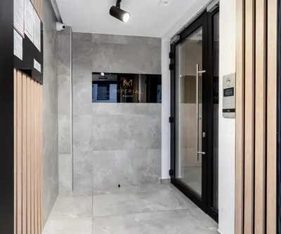 a walk in shower in a room with a glass door at Imperial Capital Apartments by BookingHost in Kraków