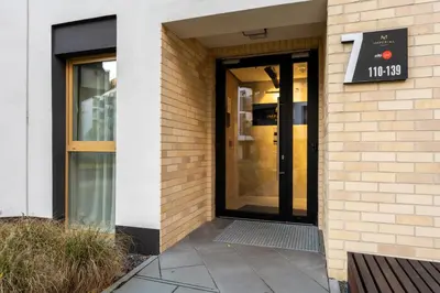a door to a building with a sign on it at Imperial Capital Apartments by BookingHost in Kraków