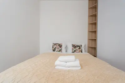 a bedroom with a bed with towels on it at Imperial Capital Apartments by BookingHost in Kraków