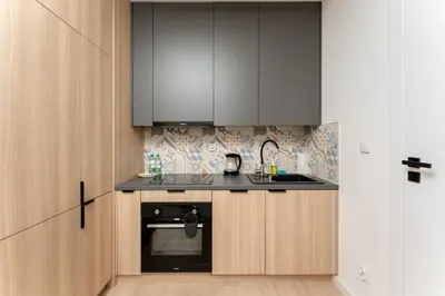 a kitchen with a sink and a stove at Imperial Capital Apartments by BookingHost in Kraków