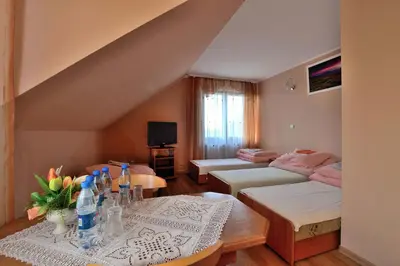 a living room with a couch and a table at Zajazd Zagłoba in Widoma