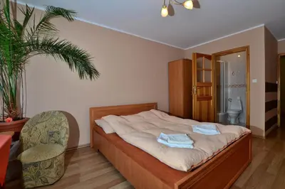a bedroom with a bed with two towels on it at Zajazd Zagłoba in Widoma