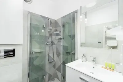 a bathroom with a shower and a sink at Househost Apartment Krowoderska 64 in Kraków