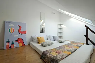 a bedroom with a bed and a wall at Urbannest-Augustiańska 4 in Kraków