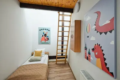a room with a bed and a ladder in it at Urbannest-Augustiańska 4 in Kraków