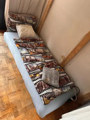 a bed with a quilt on it in a room at Villatopol Art Hostel in Rząska