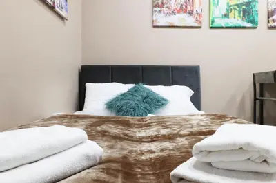 a bedroom with a bed with a blanket and pillows at Zyblikiewicza 11 by Homeprime in Kraków