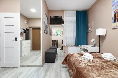 a bedroom with a bed and a living room at Zyblikiewicza 11 by Homeprime in Kraków