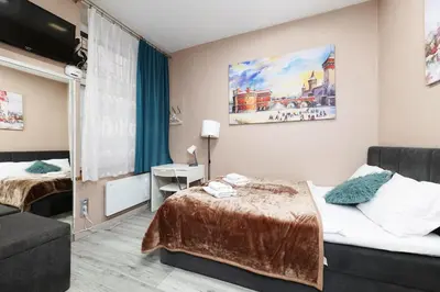 a hotel room with a bed and a couch at Zyblikiewicza 11 by Homeprime in Kraków