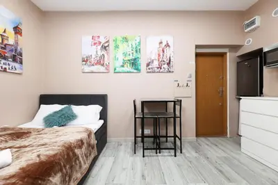 a bedroom with a bed and a table in it at Zyblikiewicza 11 by Homeprime in Kraków