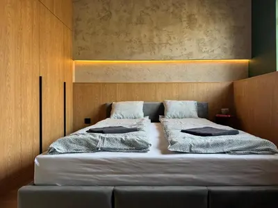 a bedroom with two beds with pillows on it at Green Point - Design Apartaments in Kraków