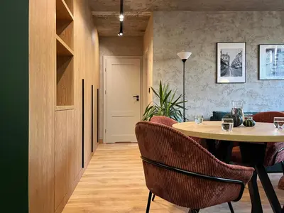a dining room with a table and chairs at Green Point - Design Apartaments in Kraków