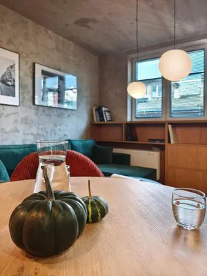 two pumpkins are sitting on a wooden table at Green Point - Design Apartaments in Kraków
