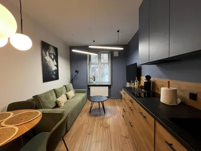 a living room with a couch and a table at Old Town Krakow Loft - Design Apartaments in Kraków