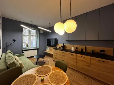 a living room with a couch and a table at Old Town Krakow Loft - Design Apartaments in Kraków