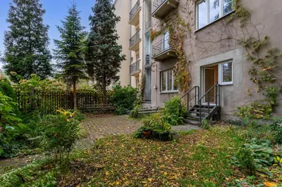 an apartment building with a yard in front of it at Apartament Lea Garden in Kraków
