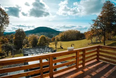 a group of benches on a deck with a view at Zachód Beskidu domek z Jacuzzi na wyłączność in Nowe Rybie