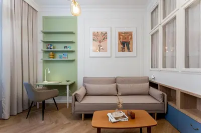 a living room with a couch and a table at San Benedetto Stylish Apartments in Kraków