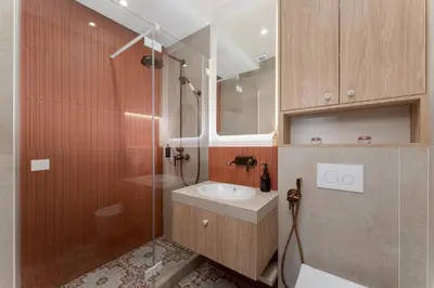 a bathroom with a sink and a shower at San Benedetto Stylish Apartments in Kraków