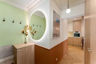 a hallway of a home with a vase of flowers at San Benedetto Stylish Apartments in Kraków