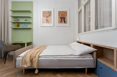 a bedroom with a bed and a desk and a chair at San Benedetto Stylish Apartments in Kraków