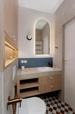 a bathroom with a sink and a mirror at San Benedetto Stylish Apartments in Kraków
