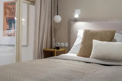 a bedroom with a bed and a mirror and a bed sidx sidx sidx at San Benedetto Stylish Apartments in Kraków