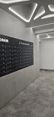 a sign on a wall in a building at Silent Apt Pychowicka in Kraków