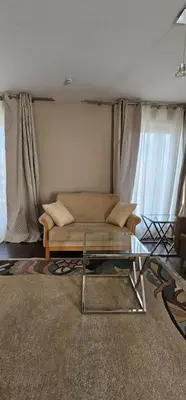 a living room with a couch and a glass table at Silent Apt Pychowicka in Kraków