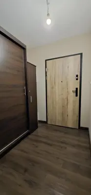 an empty room with two doors and a wooden floor at Silent Apt Pychowicka in Kraków