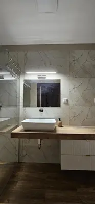 a bathroom with a sink and a mirror at Silent Apt Pychowicka in Kraków