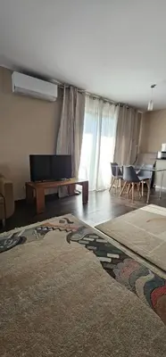 a living room with a television and a table and chairs at Silent Apt Pychowicka in Kraków