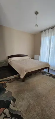 a large bed in a room with a rug at Silent Apt Pychowicka in Kraków