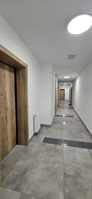 an empty hallway in an office building with a large ceiling at Silent Apt Pychowicka in Kraków