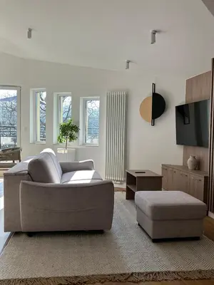 a living room with a couch and a tv at Cracow Center Jacuzzi & Sauna Penthouse Retreat in Kraków