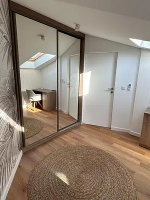 a room with a large mirror and a table at Cracow Center Jacuzzi & Sauna Penthouse Retreat in Kraków
