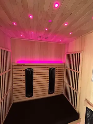 an empty room with pink lights on the ceiling at Cracow Center Jacuzzi & Sauna Penthouse Retreat in Kraków