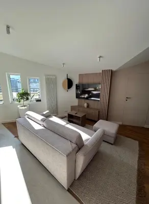 a living room with a couch and a table at Cracow Center Jacuzzi & Sauna Penthouse Retreat in Kraków