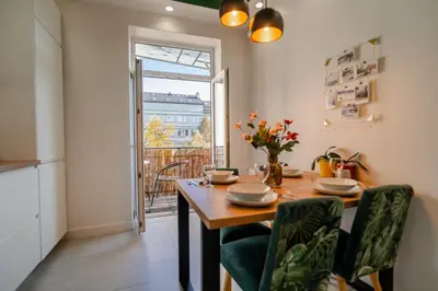 a kitchen and dining room with a table and chairs at Kraków Suite - Balcony, Workspace - by Rentujemy in Kraków