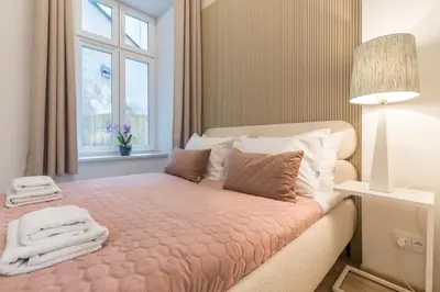 a bedroom with a bed with towels on it at CracWoW S31 Apartment in Kraków