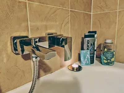 a bathroom sink with a faucet on a sink at Cozy Studio for a Couple - 10 min from the airport in Kraków