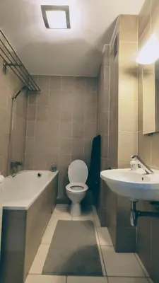a bathroom with a tub and a toilet and a sink at Cozy Studio for a Couple - 10 min from the airport in Kraków