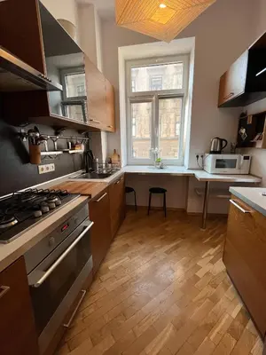a kitchen with a stove and a sink and a window at Spacious Flat in Kraków