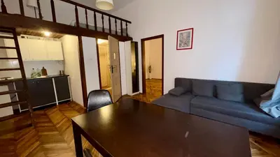 a living room with a couch and a table at Next to Main Square in Kraków