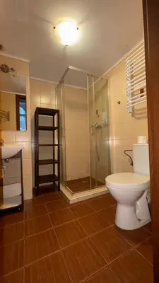 a bathroom with a shower and a toilet and a sink at Next to Main Square in Kraków