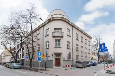 a large white building with a balcony on a street at Comfy Apartment Lubelska Krakow by Noclegi Renters in Kraków